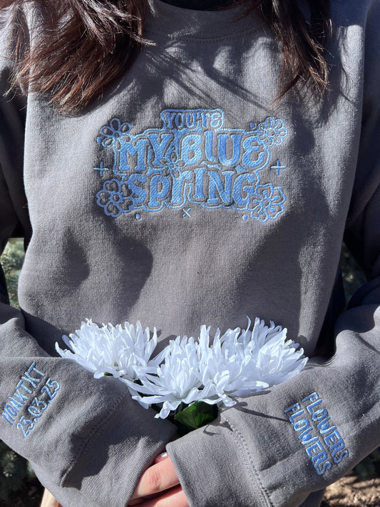 Charcoal Sweatshirt with baby blue thread that says my blue spring and sleeves say flowers flowers and moa x txt 23.03.25
